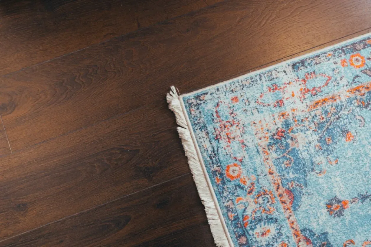 A cleaned blue Oriental rug on a hardwood floor