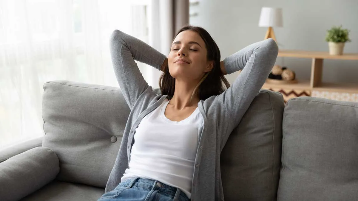 A homeowner relaxing on a sofa in a home with clean indoor air