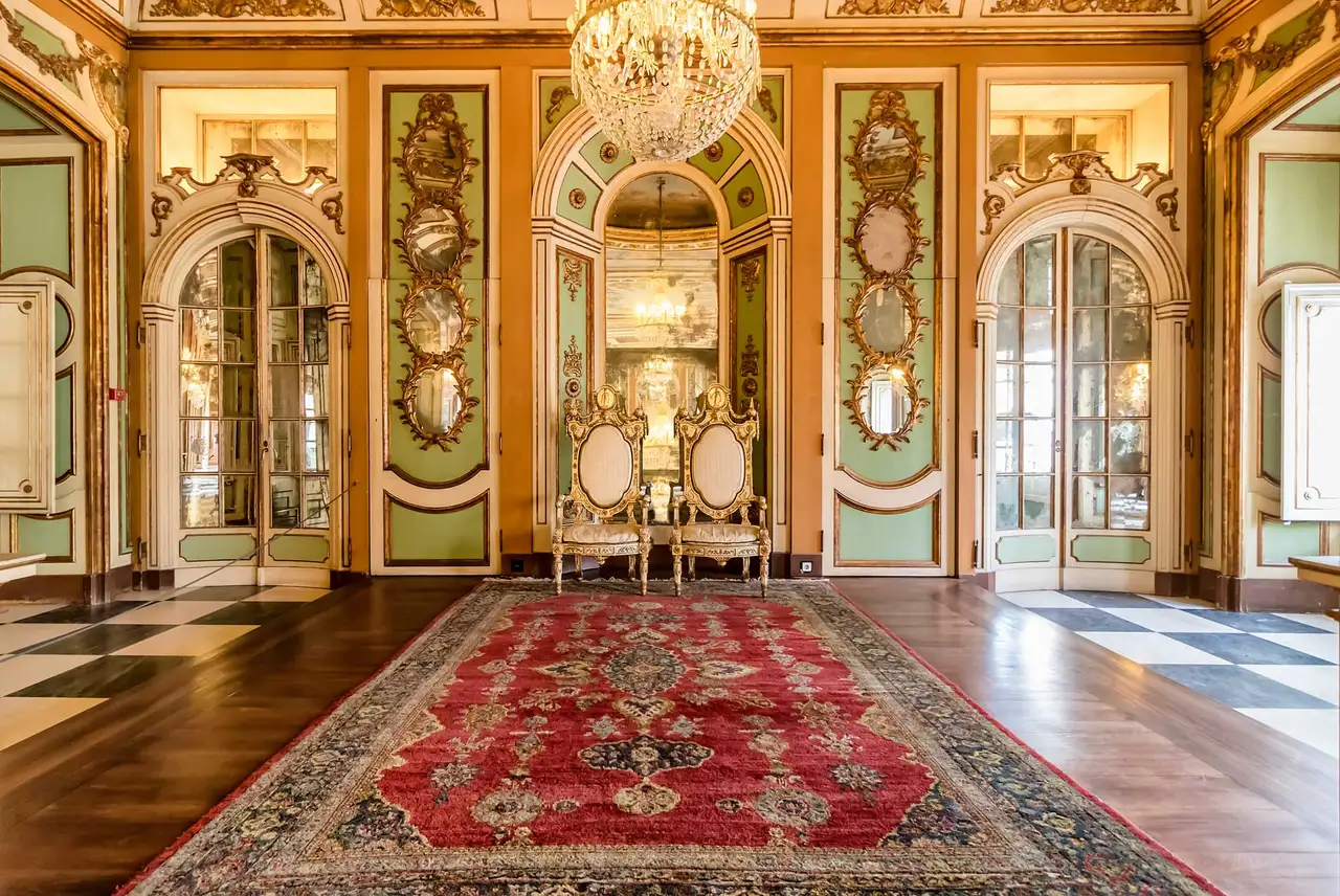 An Oriental area rug on the polished floor of a formal, high-end living room