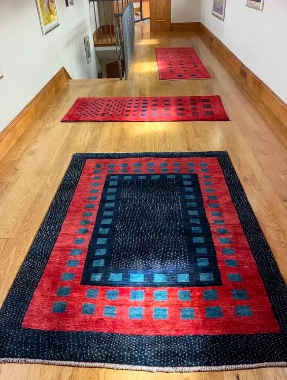 Cleaned area rugs delivered and laid back in place along a hardwood hallway